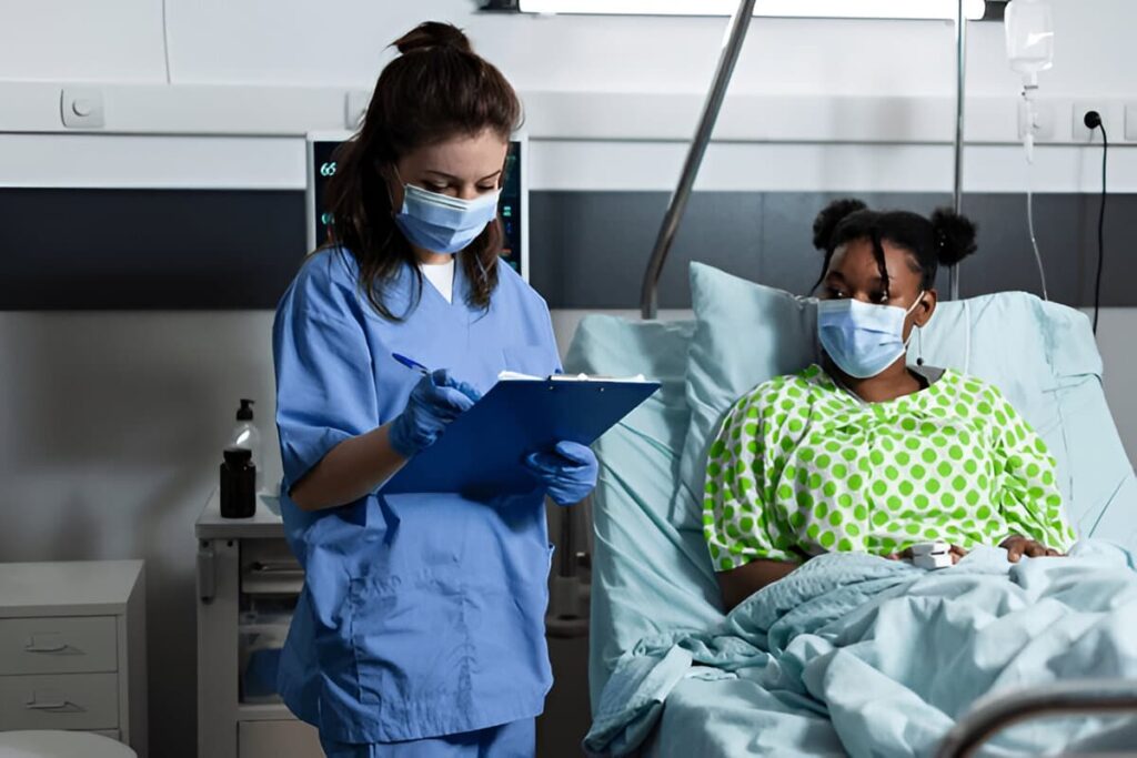 A nurse checks on a patient in a hospital ward, illustrating how medical records may be scrutinized during disability insurance surveillance.